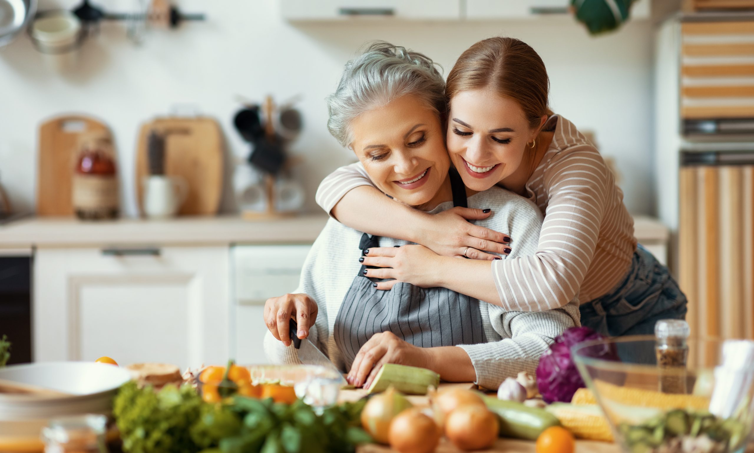 Happy mother and daughter preparing healthy food at home