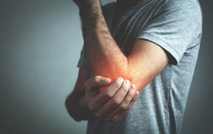 Caucasian man with elbow pain. Pain relief concept