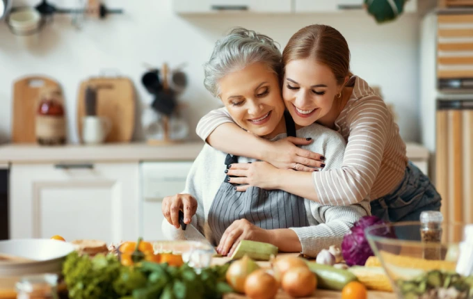 Happy mother and daughter preparing healthy food at home